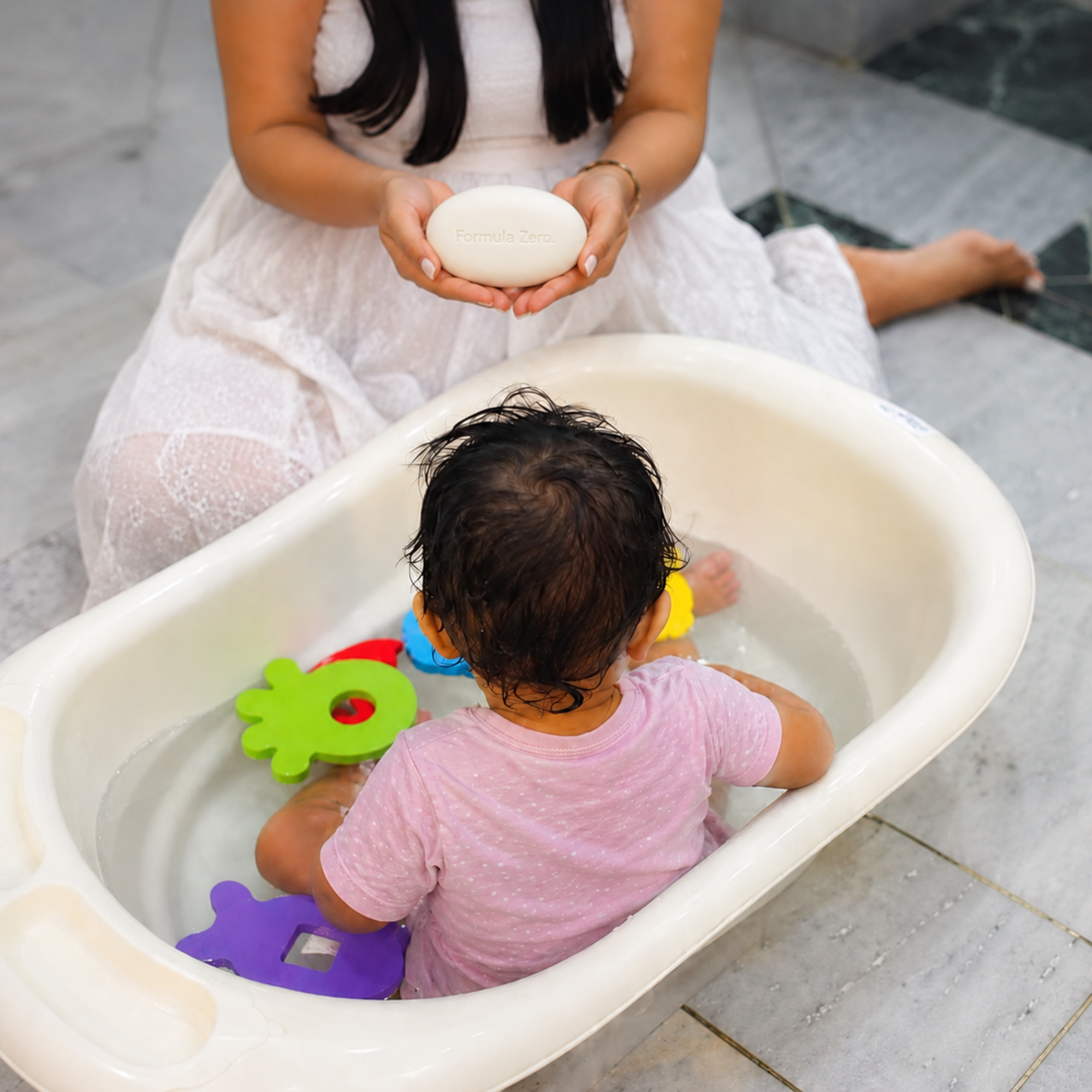 Mother bathing baby with Formula Zero Baby Cleansing Bar
